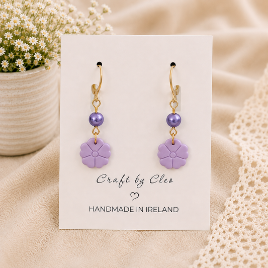 Daisy polymer clay earrings with pearl accent.